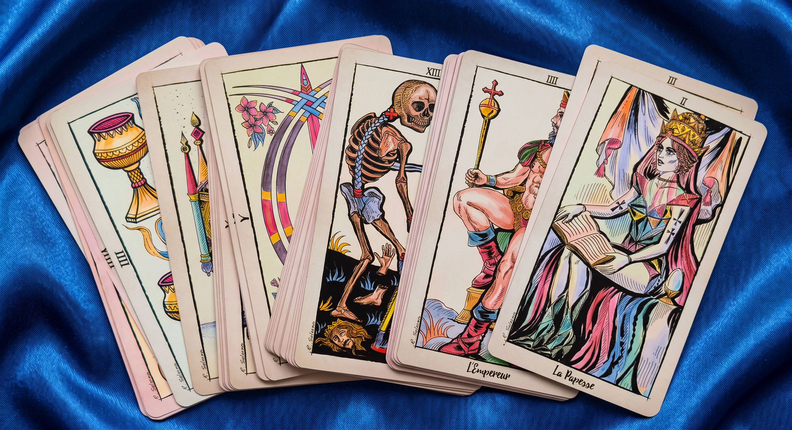 New Choice Tarot de Marseille cards fanned on blue silk